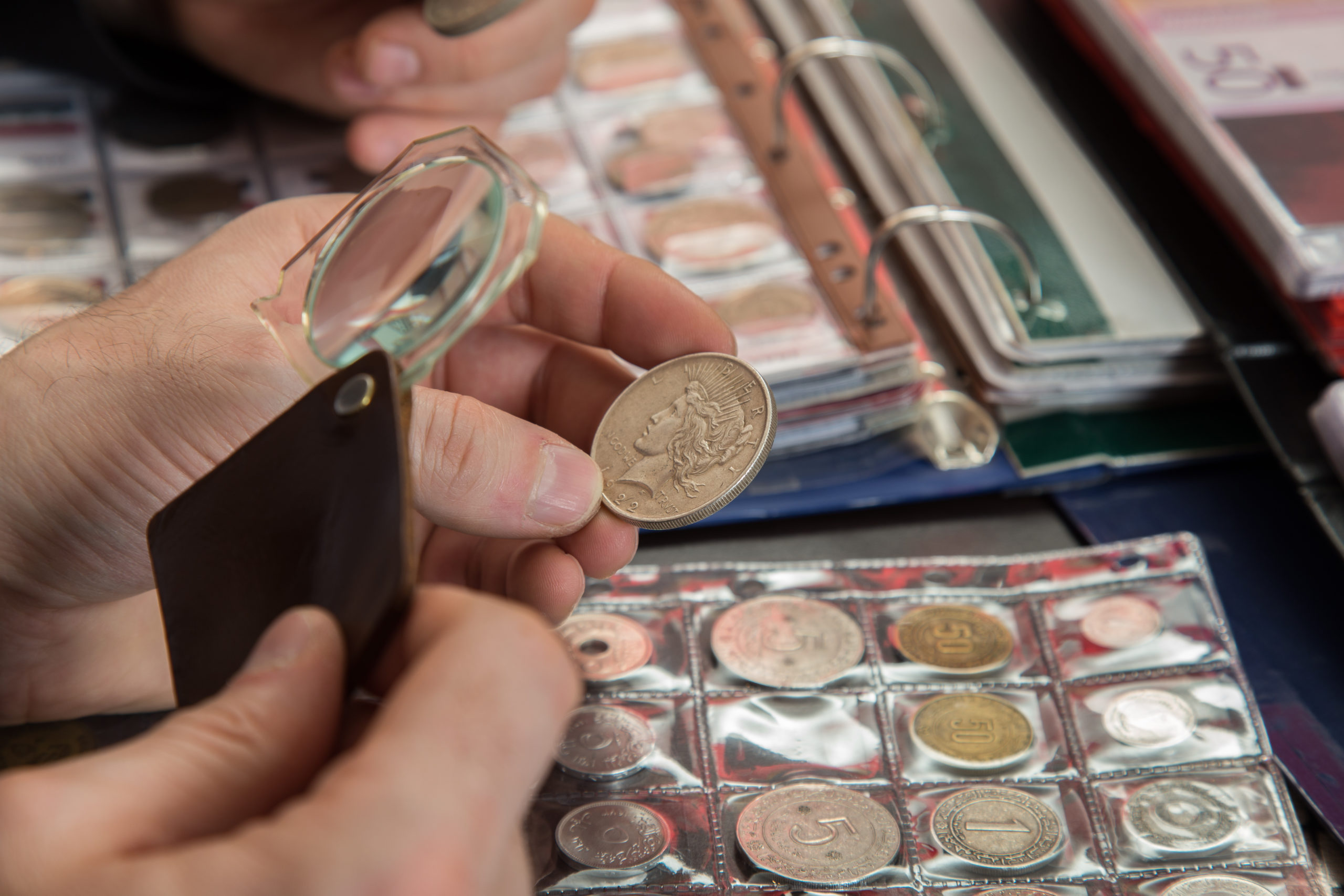 magnify glass being used to inspect a coin